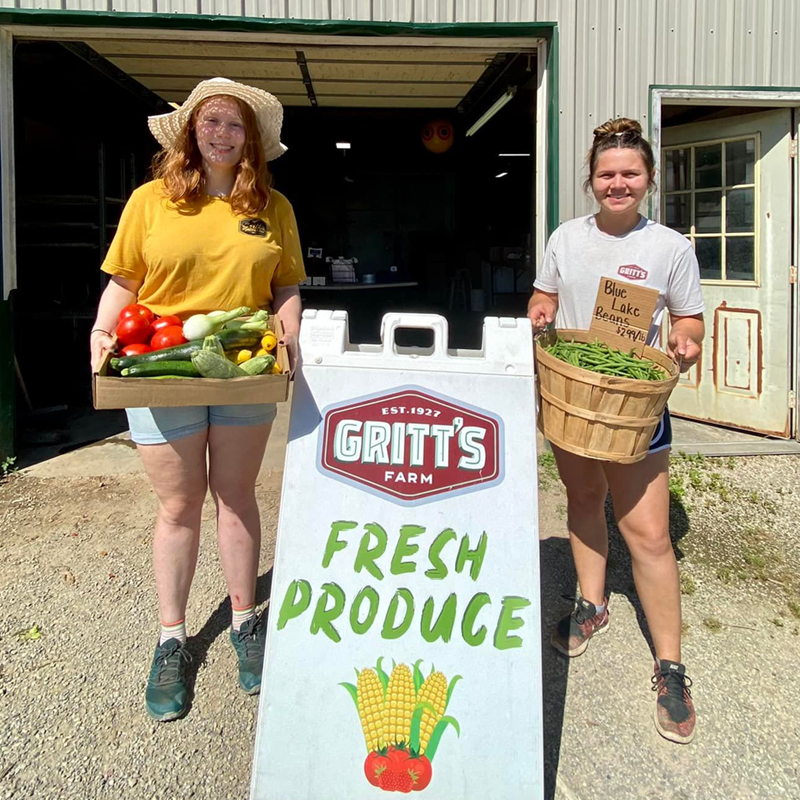 Two Employees Holding Baskets Of Produce Two Employees Holding Baskets Of Produce